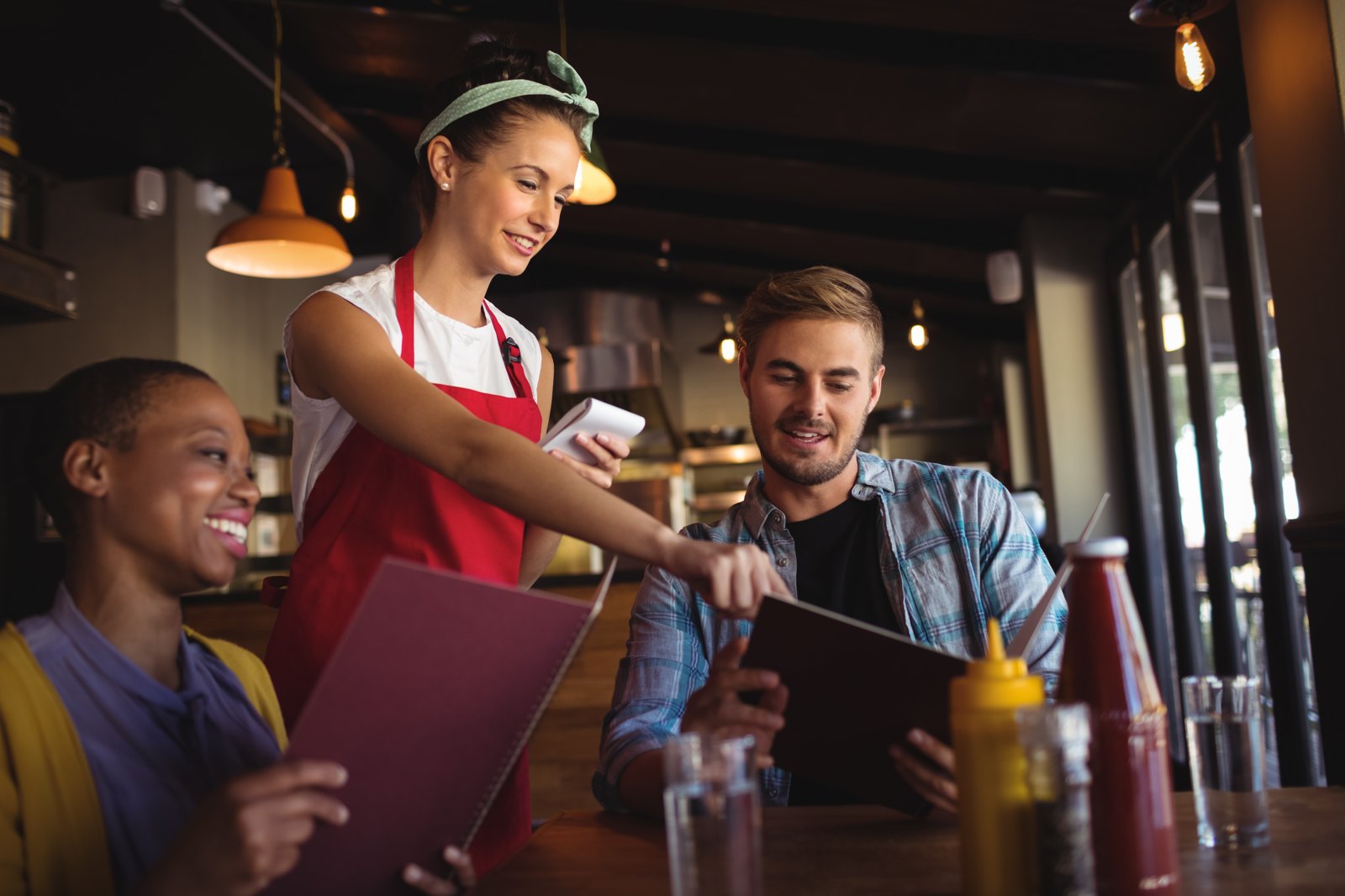 Server taking an order from guests in a restaurant